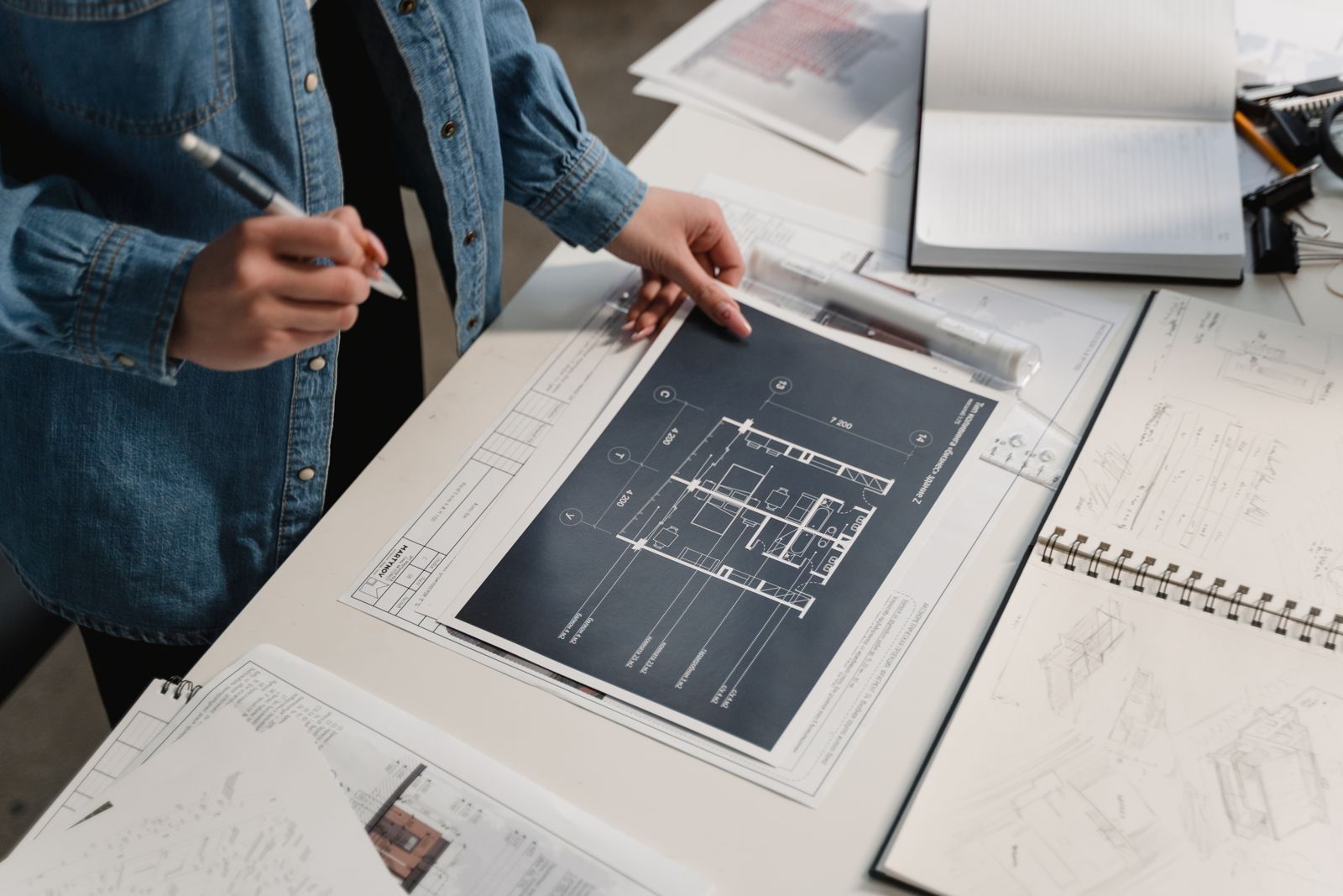 An engineer reviewing architectural drawings at a desk