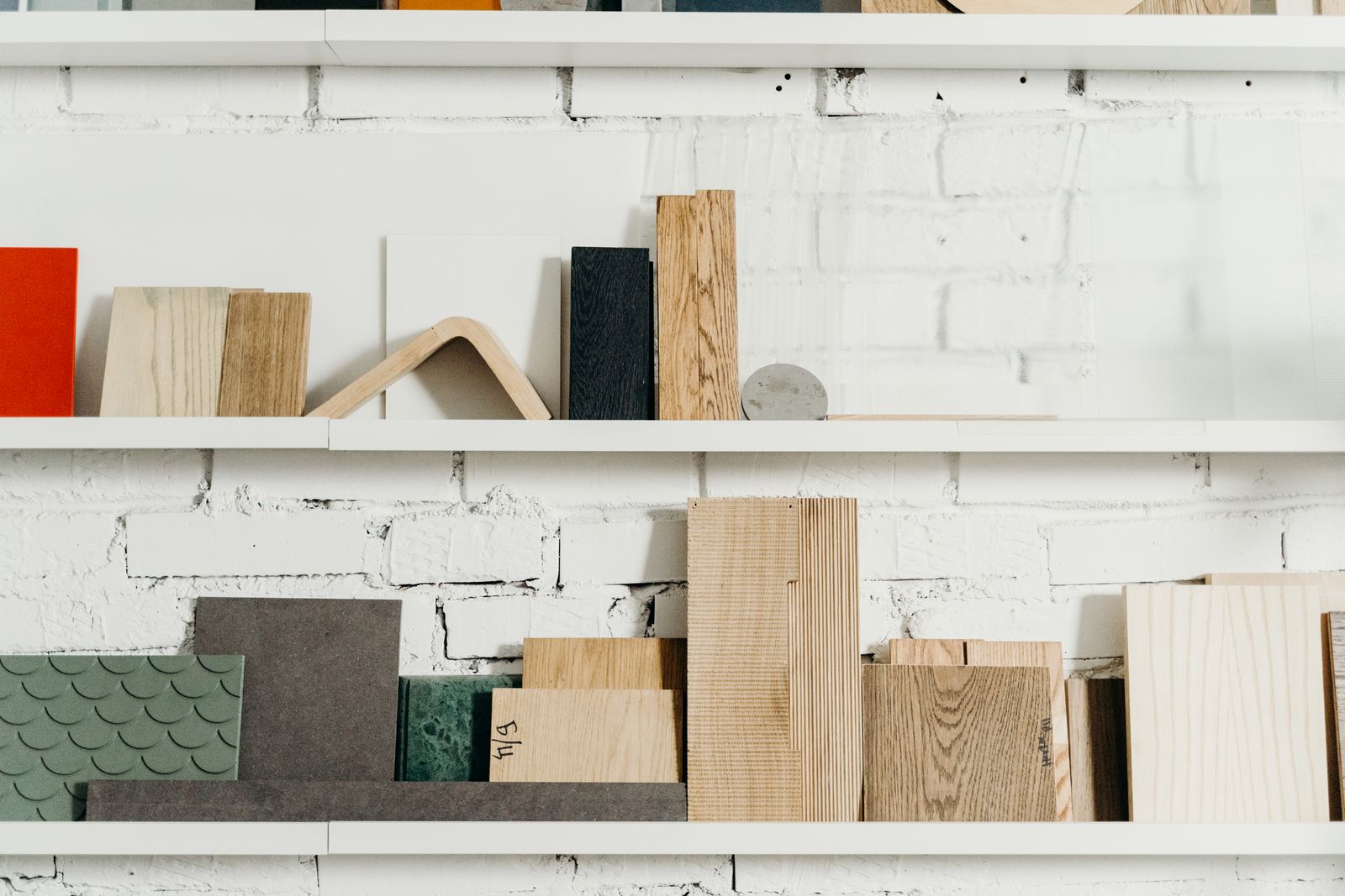 Shelves of material samples and timber in the atelier warehouse